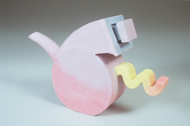 A pink fleeing teapot with a yellow tail and a purple hat