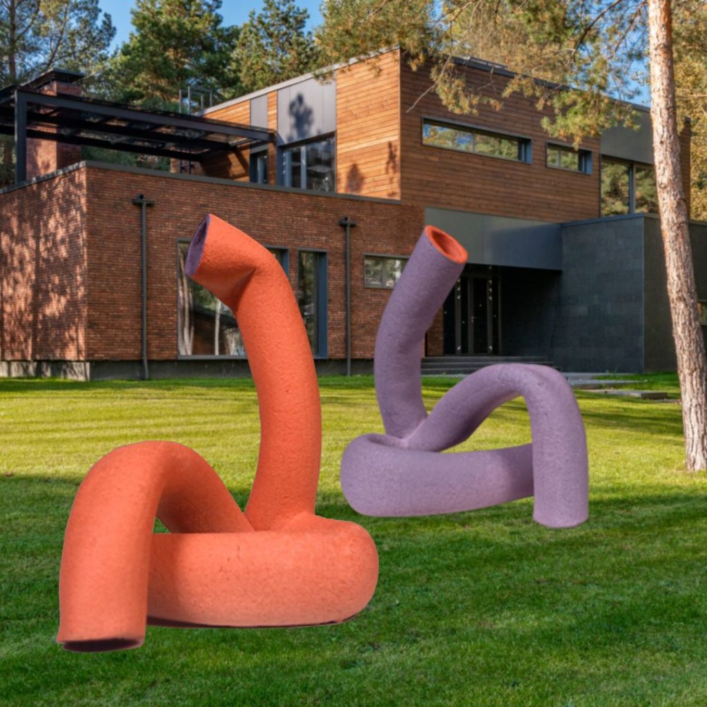 Pink and purple sculptures in front of a library